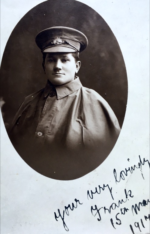 black and white portrait of man wearing coat and cap