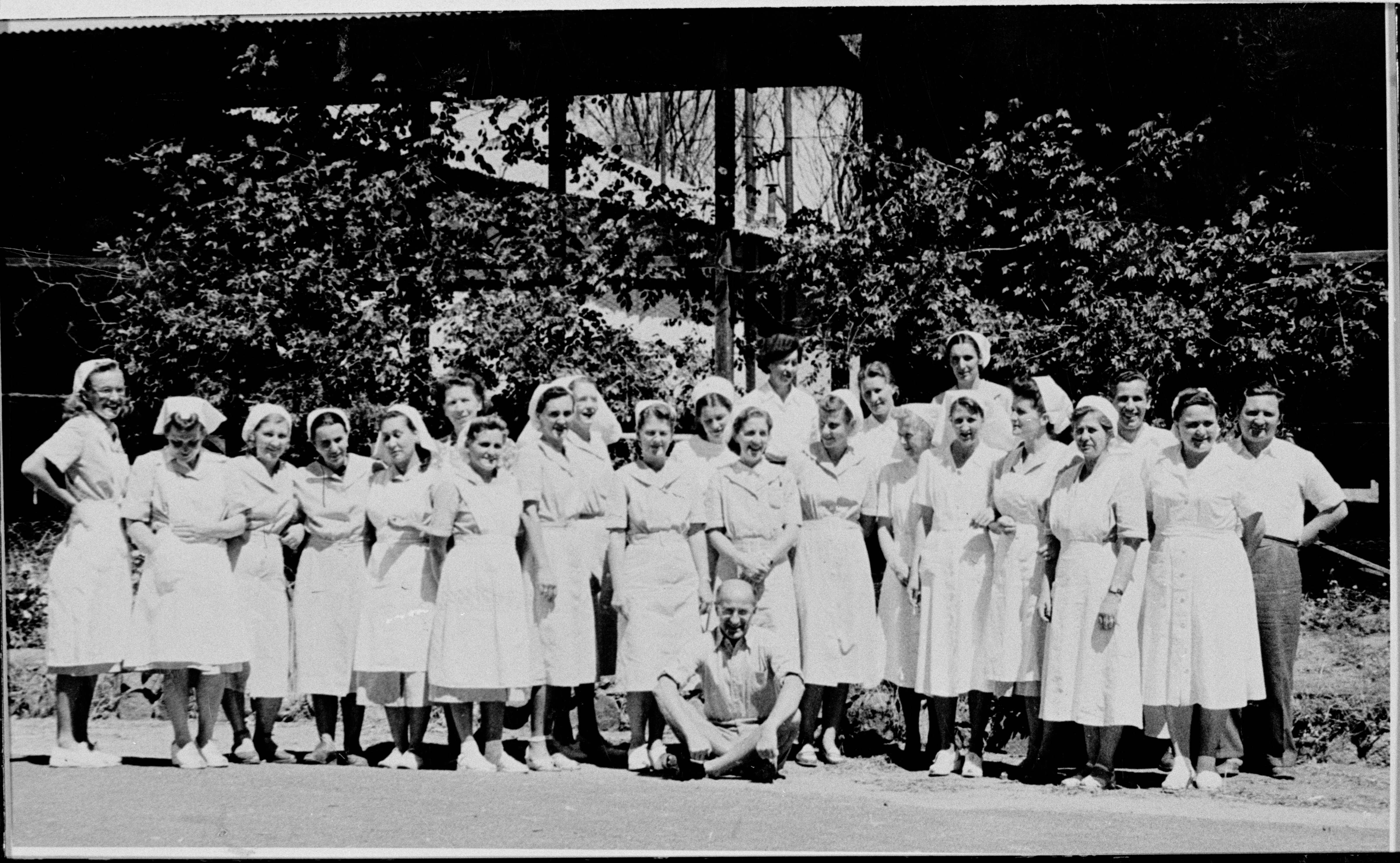 black and white photo of men and women standing