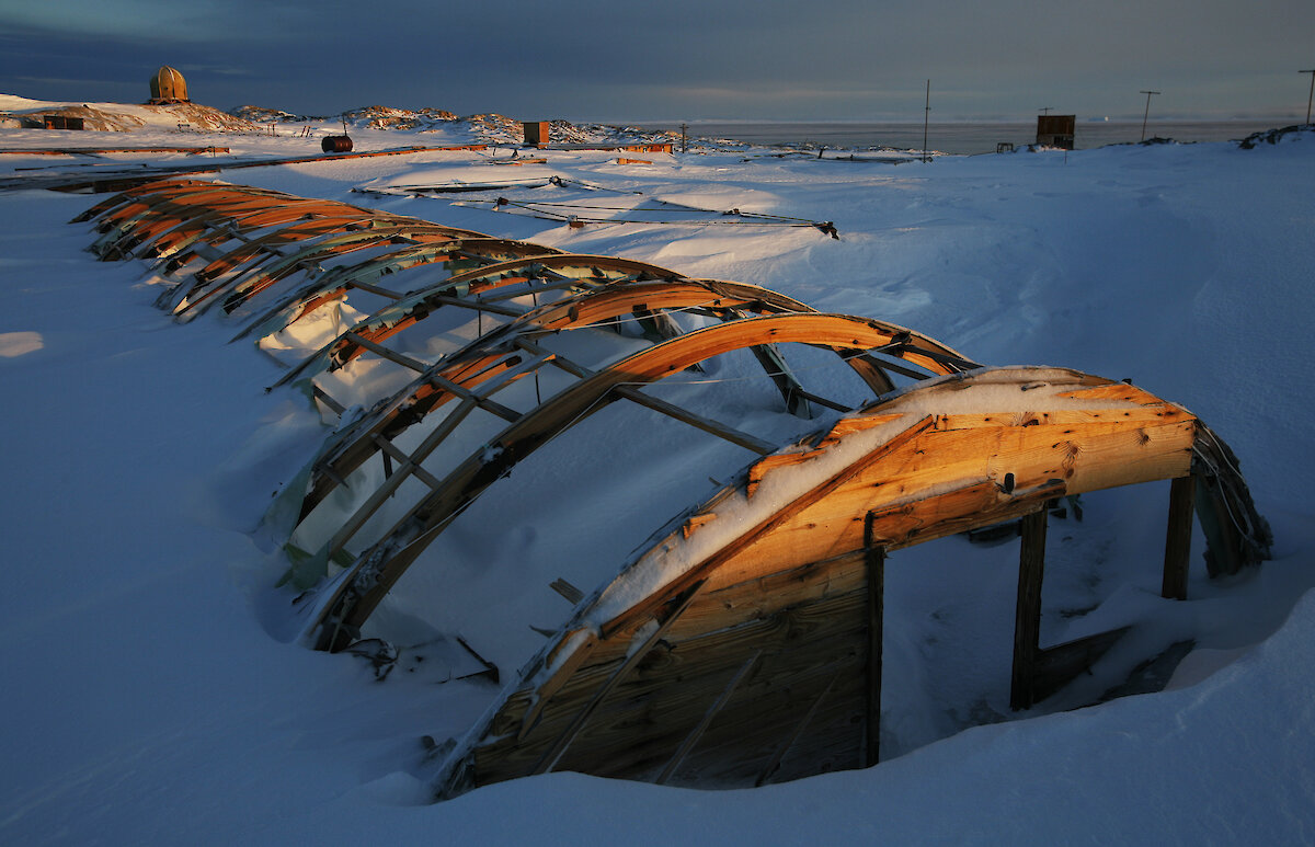 Photo of shell of structure partially covered by snow