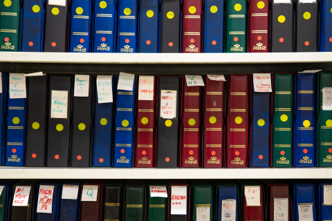 Colourful folders on shelves