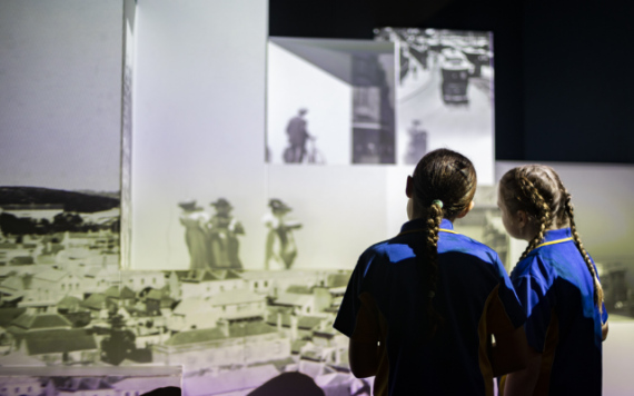 Two children looking at old photos